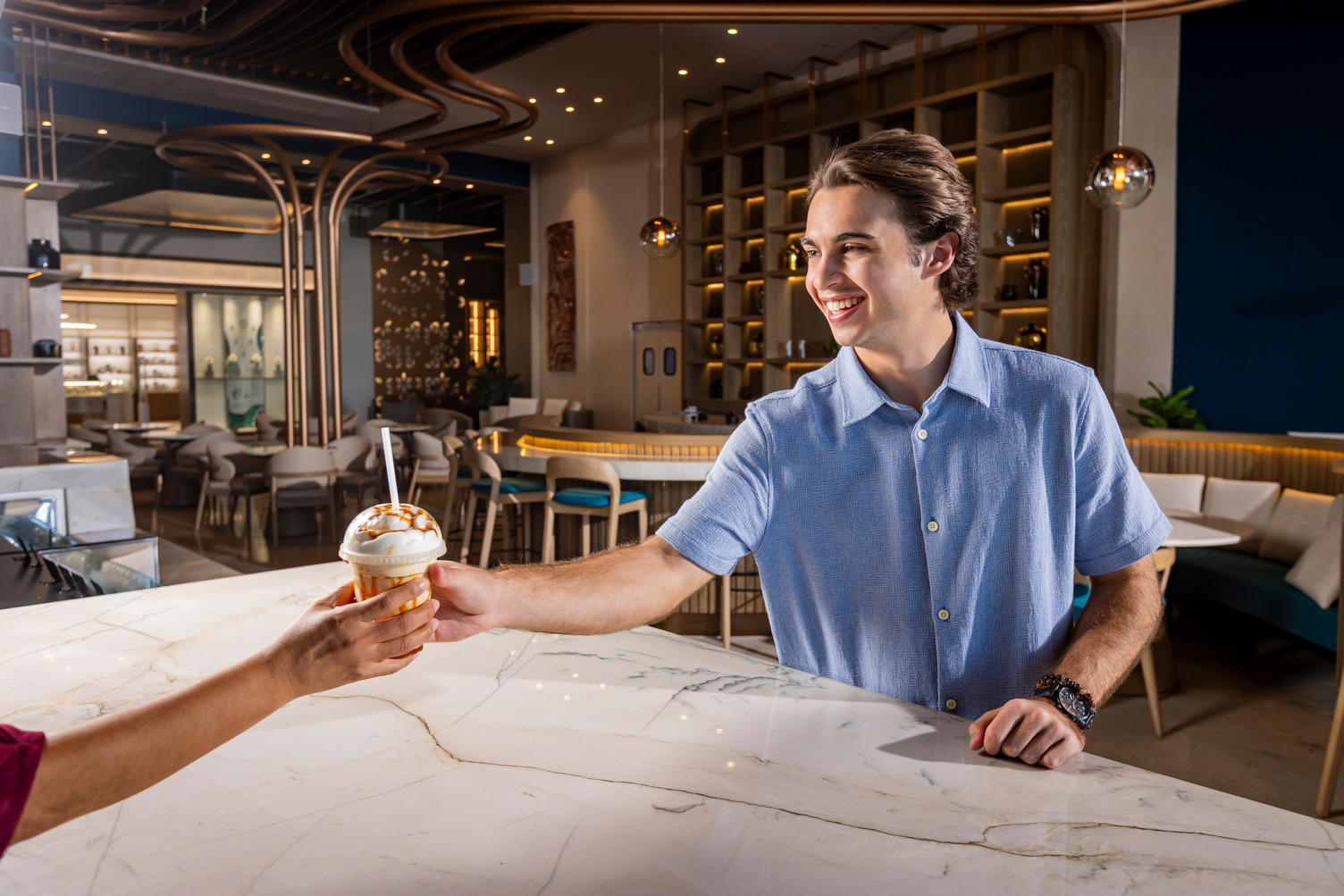 a person handing a cup to a man